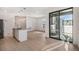 Open-concept kitchen and living area with hardwood flooring, bright lighting, and a sliding glass door at 2032 S Holly St # 3, Denver, CO 80222