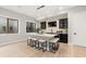 Contemporary wet bar with custom cabinetry, stone backsplash, pendant lighting, and barstool seating at 6122 Maroon Peak Pl, Castle Rock, CO 80108