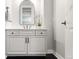This bathroom features a black countertop and vanity with a beveled mirror at 6122 Maroon Peak Pl, Castle Rock, CO 80108