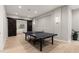 This game room features barn doors to the bedroom and a ping pong table at 6122 Maroon Peak Pl, Castle Rock, CO 80108