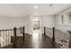 Second story landing with iron railing overlooking the main level at 6122 Maroon Peak Pl, Castle Rock, CO 80108