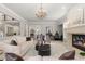 Bright living room featuring a fireplace, elegant furnishings, and plenty of natural light at 6122 Maroon Peak Pl, Castle Rock, CO 80108