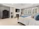 Main bedroom with a fireplace, tray ceiling, sitting area, and many windows providing natural light at 6122 Maroon Peak Pl, Castle Rock, CO 80108