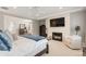 Spacious main bedroom featuring a cozy fireplace, sitting area, and view of the en suite bathroom and closet at 6122 Maroon Peak Pl, Castle Rock, CO 80108