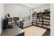 Well lit office space with desk, bright window, hard wood floors, and built-in bookshelves at 6122 Maroon Peak Pl, Castle Rock, CO 80108