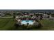 Aerial view of a community pool with a large pool, clubhouse, and surrounding buildings at 6122 Maroon Peak Pl, Castle Rock, CO 80108