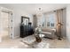Sitting room with large window, tufted sofa, chandelier, and ample light at 6122 Maroon Peak Pl, Castle Rock, CO 80108