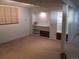 Finished basement with built-in shelving and a carpeted floor at 2603 W 100Th Pl, Federal Heights, CO 80260