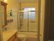 Bathroom with tub shower, glass enclosure, and updated vanity at 2603 W 100Th Pl, Federal Heights, CO 80260