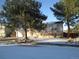Brick house with snow-covered yard and mature trees at 2603 W 100Th Pl, Federal Heights, CO 80260