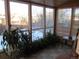 Sunroom with large windows, tile floors, and potted plants at 2603 W 100Th Pl, Federal Heights, CO 80260