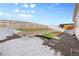 Landscaped backyard with retaining wall, artificial turf, and stone pathway at 5695 Cadara Way, Parker, CO 80134