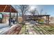 Spacious backyard with a stone path, wooden pergola with furniture and outdoor grill at 954 E Costilla Ave, Centennial, CO 80122