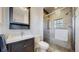 Modern bathroom with white-tiled shower, dark vanity, and patterned tile flooring for a sleek and contemporary look at 954 E Costilla Ave, Centennial, CO 80122