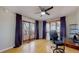 Bright bedroom featuring wood floors, a ceiling fan, and sliding glass doors leading to a balcony at 954 E Costilla Ave, Centennial, CO 80122