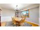 Inviting dining area with wood table, chairs, and a large window providing natural light and neighborhood views at 954 E Costilla Ave, Centennial, CO 80122