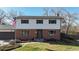 Traditional two-story home with brick facade and manicured lawn, showcasing classic American architecture at 954 E Costilla Ave, Centennial, CO 80122
