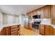 Well-equipped kitchen with stainless steel appliances, wooden cabinets, and plenty of storage space at 954 E Costilla Ave, Centennial, CO 80122