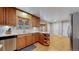 Functional kitchen featuring wooden cabinets, a stainless steel dishwasher, and ample counter space at 954 E Costilla Ave, Centennial, CO 80122