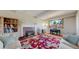 Cozy living room with fireplace, hardwood floors, and bright natural light from a large window at 954 E Costilla Ave, Centennial, CO 80122
