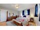 Comfortable main bedroom with wood floors, a ceiling fan, and a large dresser providing ample storage at 954 E Costilla Ave, Centennial, CO 80122