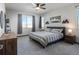 Cozy bedroom with a ceiling fan, neutral color scheme, and lots of natural light at 11659 W 44Th Ave, Wheat Ridge, CO 80033