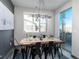 Dining room features a wood table, black metal chairs, and contemporary light fixture at 11659 W 44Th Ave, Wheat Ridge, CO 80033