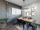 Dining room features a wood table, black metal chairs, wine rack, and contemporary light fixture at 11659 W 44Th Ave, Wheat Ridge, CO 80033