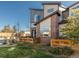 Modern townhome exterior featuring a well-maintained lawn and brick accents at 11659 W 44Th Ave, Wheat Ridge, CO 80033