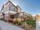 Modern townhome row showcasing mixed siding, brick, and manicured landscaping in a bright and sunny setting at 11659 W 44Th Ave, Wheat Ridge, CO 80033