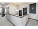 Bright hallway with stylish pendant lighting, gray accents, and a view of a bedroom at 11659 W 44Th Ave, Wheat Ridge, CO 80033