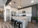 Modern kitchen with stainless steel appliances, a center island, and contemporary lighting fixtures at 11659 W 44Th Ave, Wheat Ridge, CO 80033