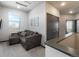 Living room space with a gray sofa, window and gray trim at 11659 W 44Th Ave, Wheat Ridge, CO 80033