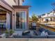 Cozy patio with outdoor seating, fire pit, grill, and sliding glass doors to the home interior at 11659 W 44Th Ave, Wheat Ridge, CO 80033