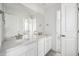 Contemporary bathroom featuring double sinks, white cabinetry, and modern fixtures at 270 Maddox Ln, Erie, CO 80516