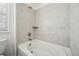 Clean bathroom with a luxurious white bathtub and tiled wall at 270 Maddox Ln, Erie, CO 80516