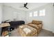 Bedroom with a bed, chair, and ottoman at 270 Maddox Ln, Erie, CO 80516