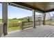 Covered deck with string lights, features an open view of a large grassy area and walking path at 270 Maddox Ln, Erie, CO 80516