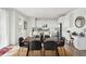 Dining room with a large table, modern chairs, and bright, white kitchen in the background at 270 Maddox Ln, Erie, CO 80516