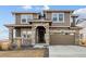 Two-story house with stone accents and a large driveway at 270 Maddox Ln, Erie, CO 80516