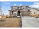 Two-story house with stone accents and a large driveway at 270 Maddox Ln, Erie, CO 80516