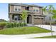 Beautiful two-story home featuring a stone facade, manicured lawn, and attached two car garage at 270 Maddox Ln, Erie, CO 80516