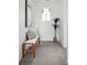 Well-lit hallway with a bench, stylish cushions, a decorative plant, and modern artwork, creating a sophisticated entrance at 270 Maddox Ln, Erie, CO 80516