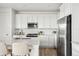 Bright kitchen featuring white cabinets and stainless steel appliances at 270 Maddox Ln, Erie, CO 80516