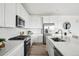 Modern kitchen with white cabinets, stainless steel appliances, and quartz countertops at 270 Maddox Ln, Erie, CO 80516