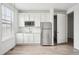Bright kitchenette featuring white cabinetry, stainless steel appliances, and a window for natural light at 270 Maddox Ln, Erie, CO 80516