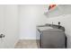 Well-organized laundry room features modern appliances, built-in shelving and tiled floor at 270 Maddox Ln, Erie, CO 80516