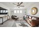 Bright living room with modern furniture, a ceiling fan, and plenty of natural light, perfect for relaxation at 270 Maddox Ln, Erie, CO 80516