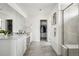 Bright main bathroom with dual sinks, sleek cabinetry, and a walk-in closet, providing a spa-like experience at 270 Maddox Ln, Erie, CO 80516