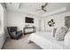 Main bedroom with a king bed, armchair, and a modern console table at 270 Maddox Ln, Erie, CO 80516